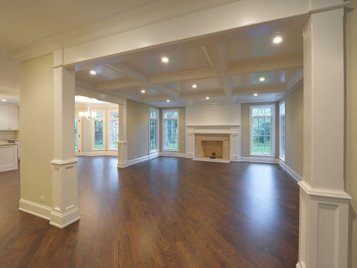 An open plan main floor running the same board through the living, dining and kitchen areas without a break